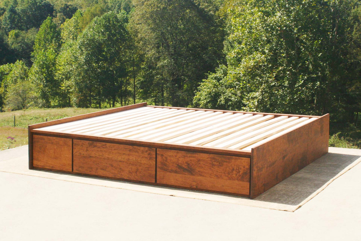 angled view natural platform bed with drawers