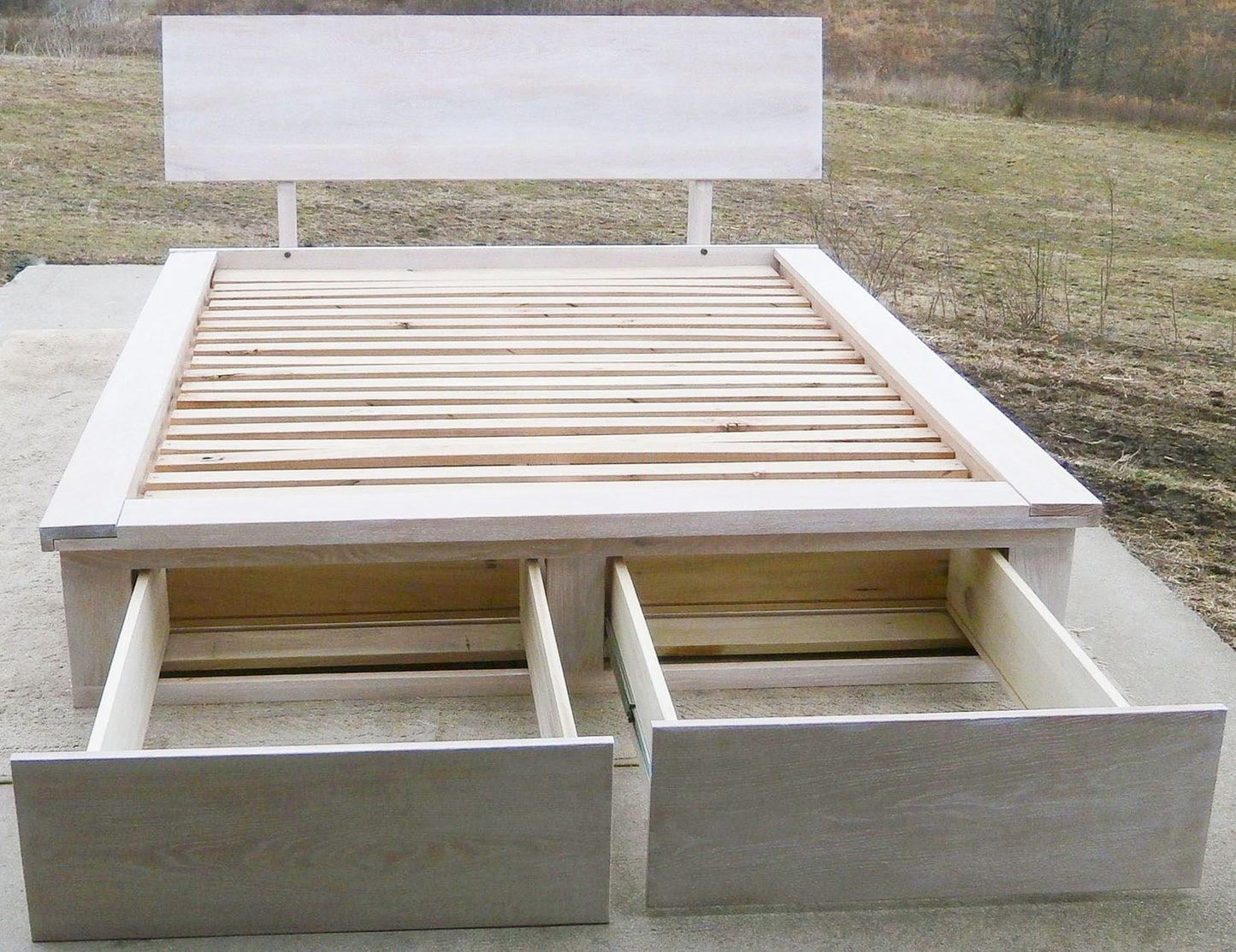 front view Platform Bed with foot-end drawers open, angled headboard and platform extension