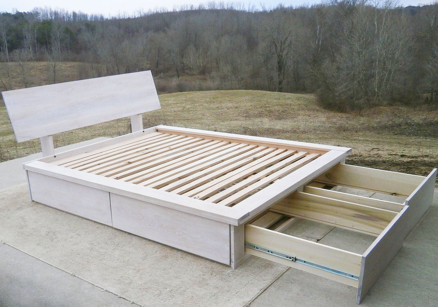 angled view Platform Bed with foot-end drawers open, angled headboard and platform extension