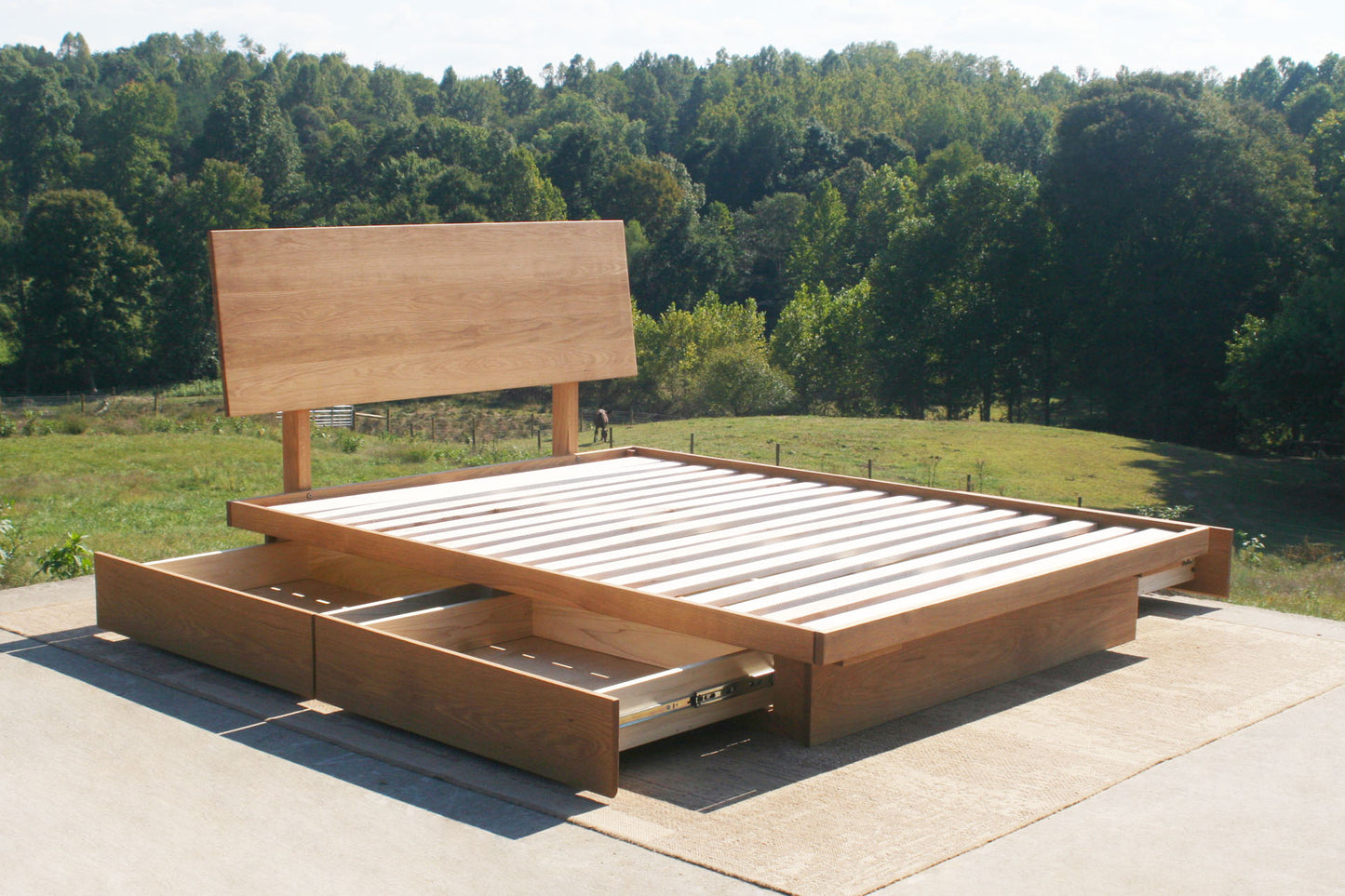 angled view low platform storage bed with 4 drawers open