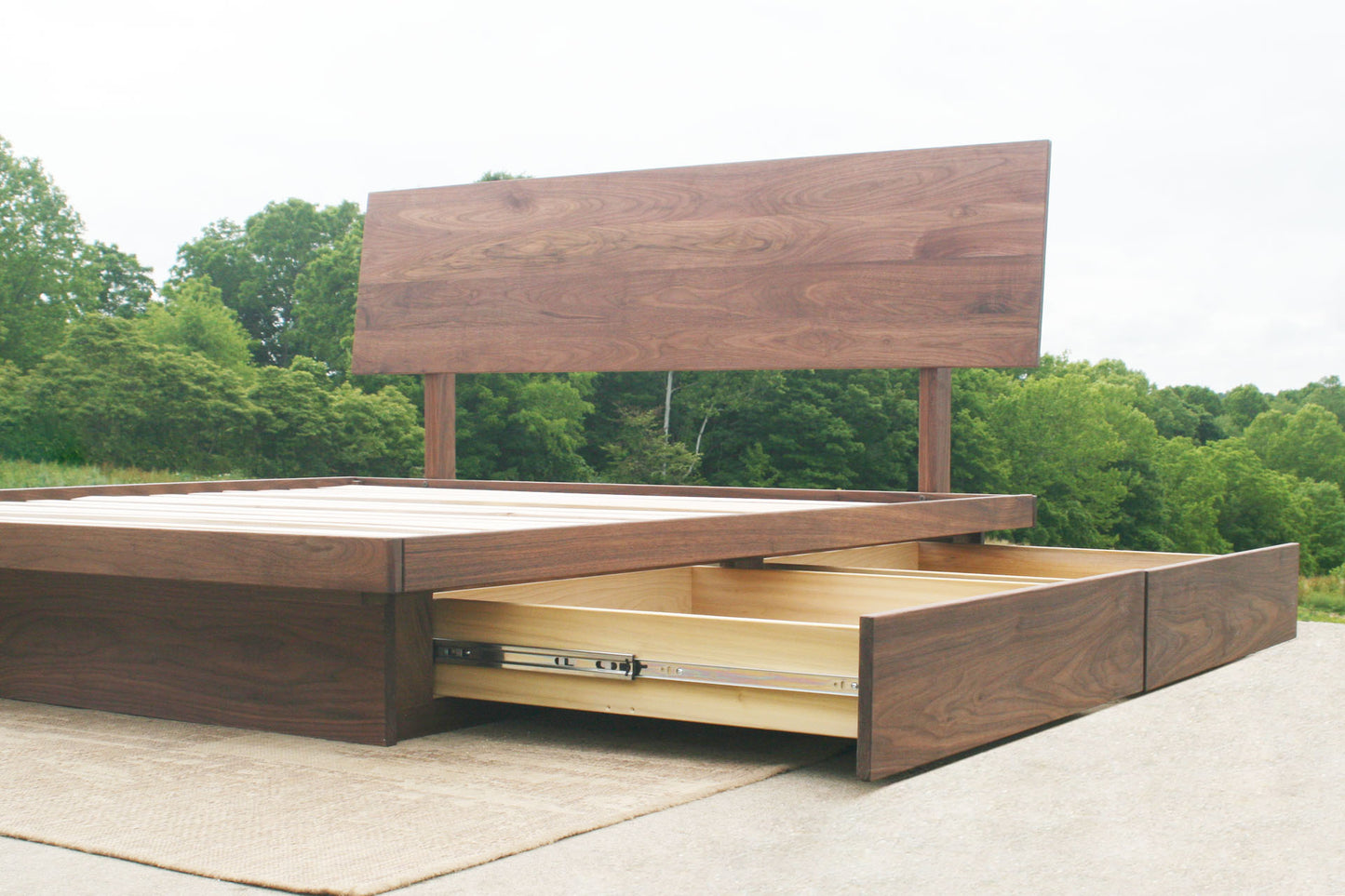 drawers out low angled view Low platform storage bed with 4 drawers