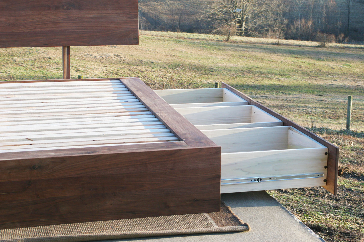 low view of natural Low Platform Bed with 6 drawers and angled headboard drawers open