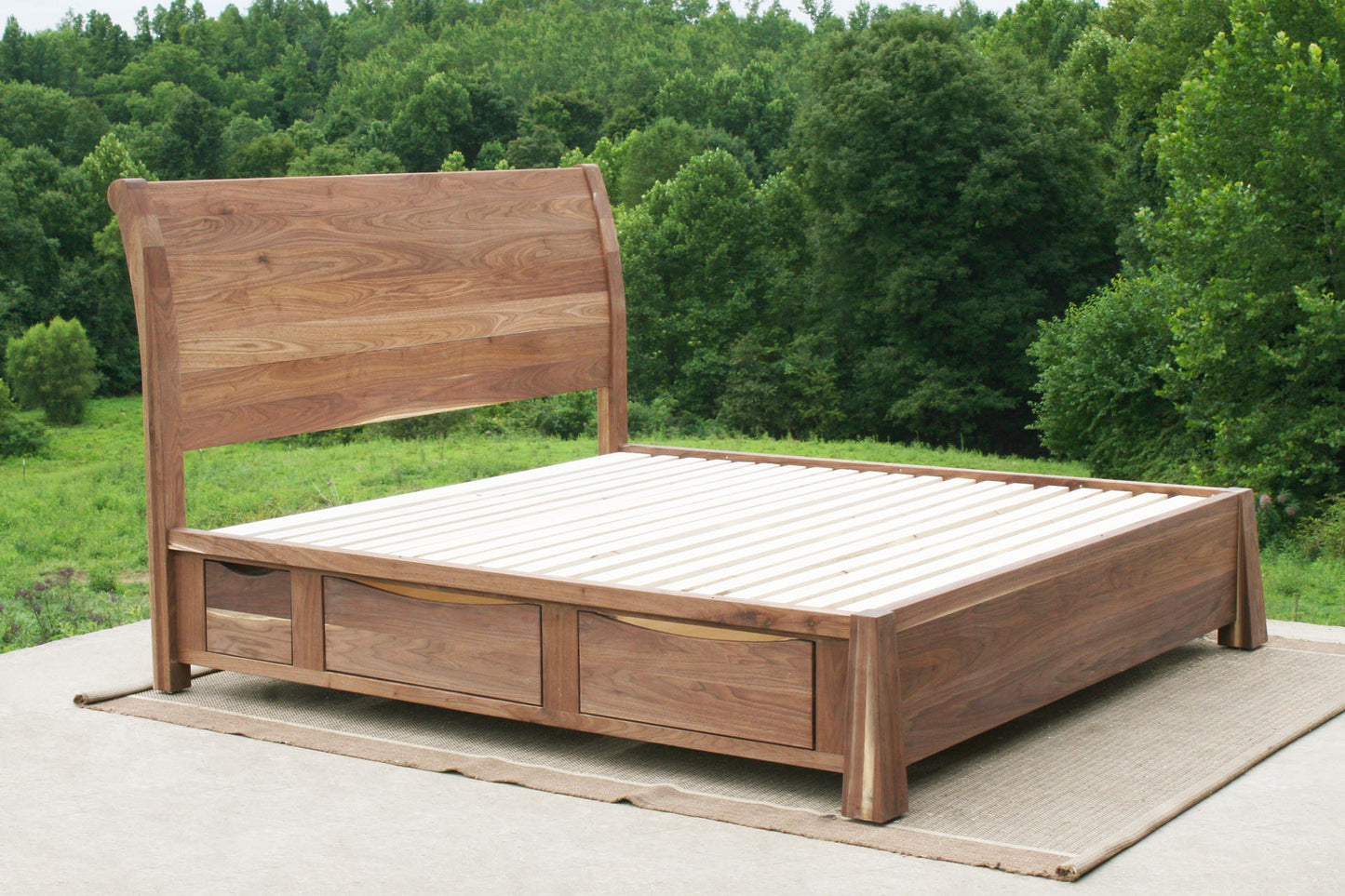 angled view of solid wood Sleigh Platform bed with 4 drawers and large posts