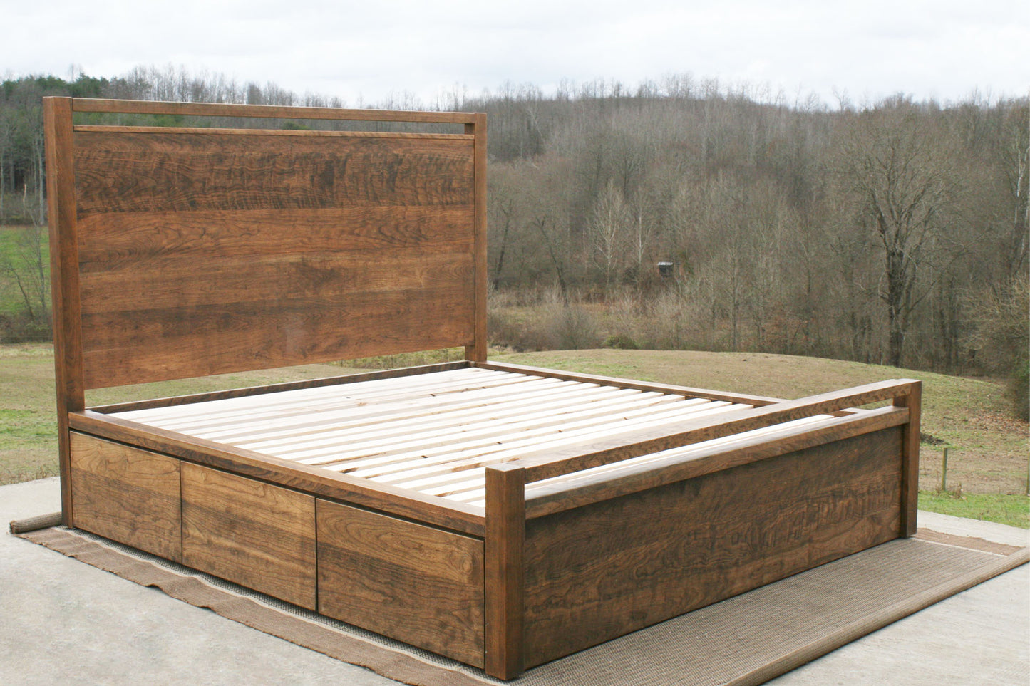 side angled view natural hardwood Storage Bed with top-rail head and footboard