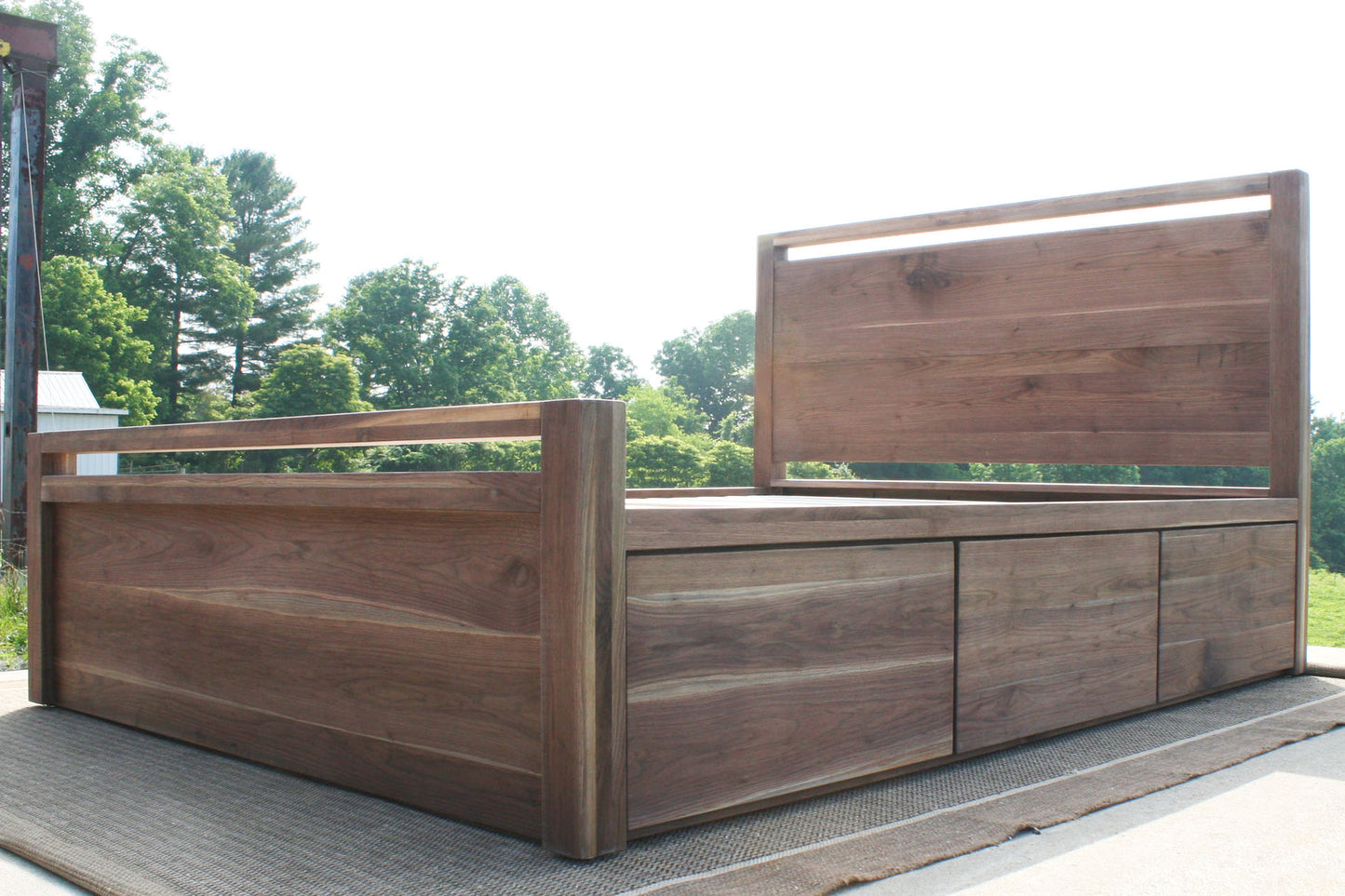 low angled view Storage Bed with top-rail head and footboard