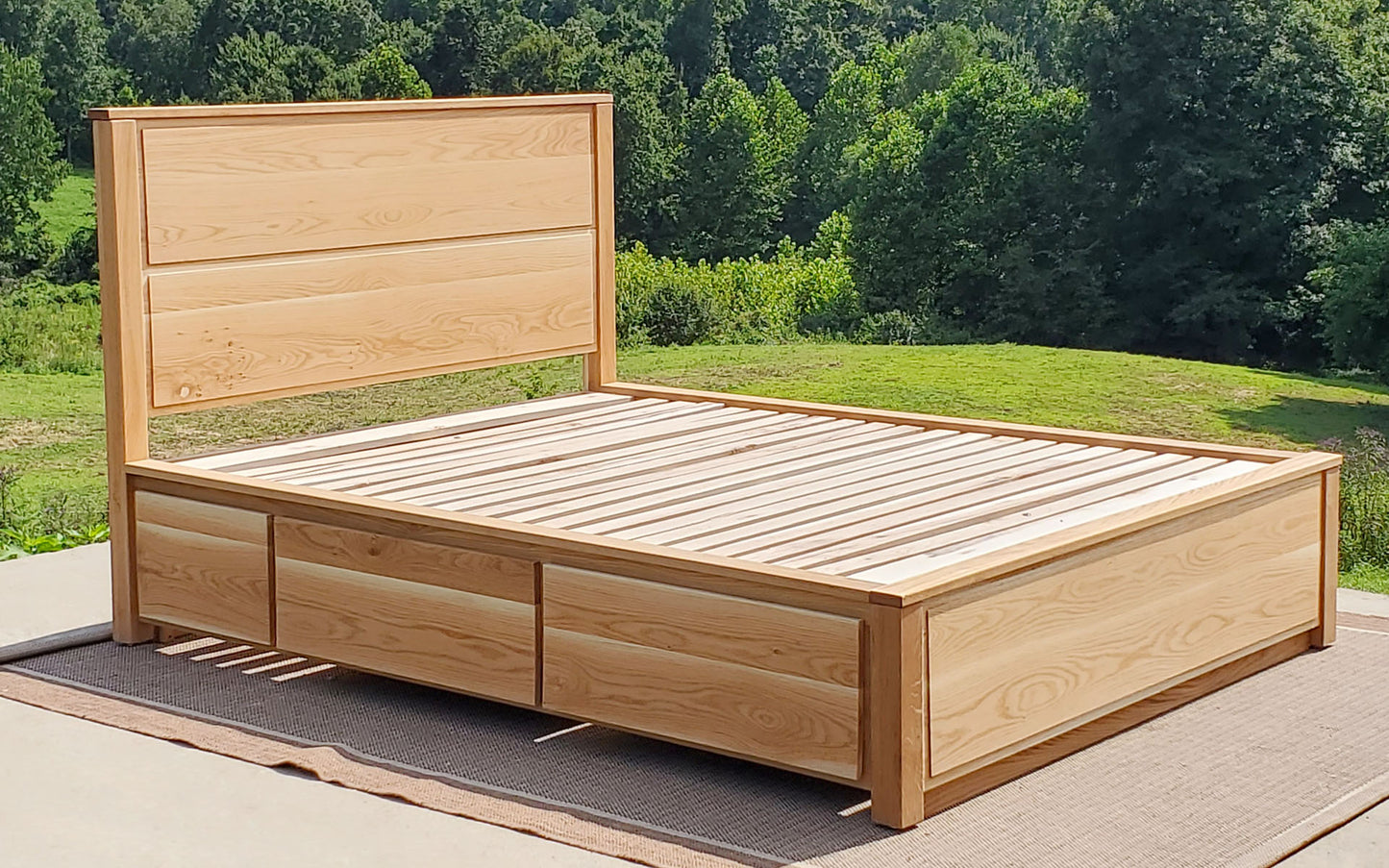 angled view Storage Bed with 4 drawers, recessed frame headboard and toe kick