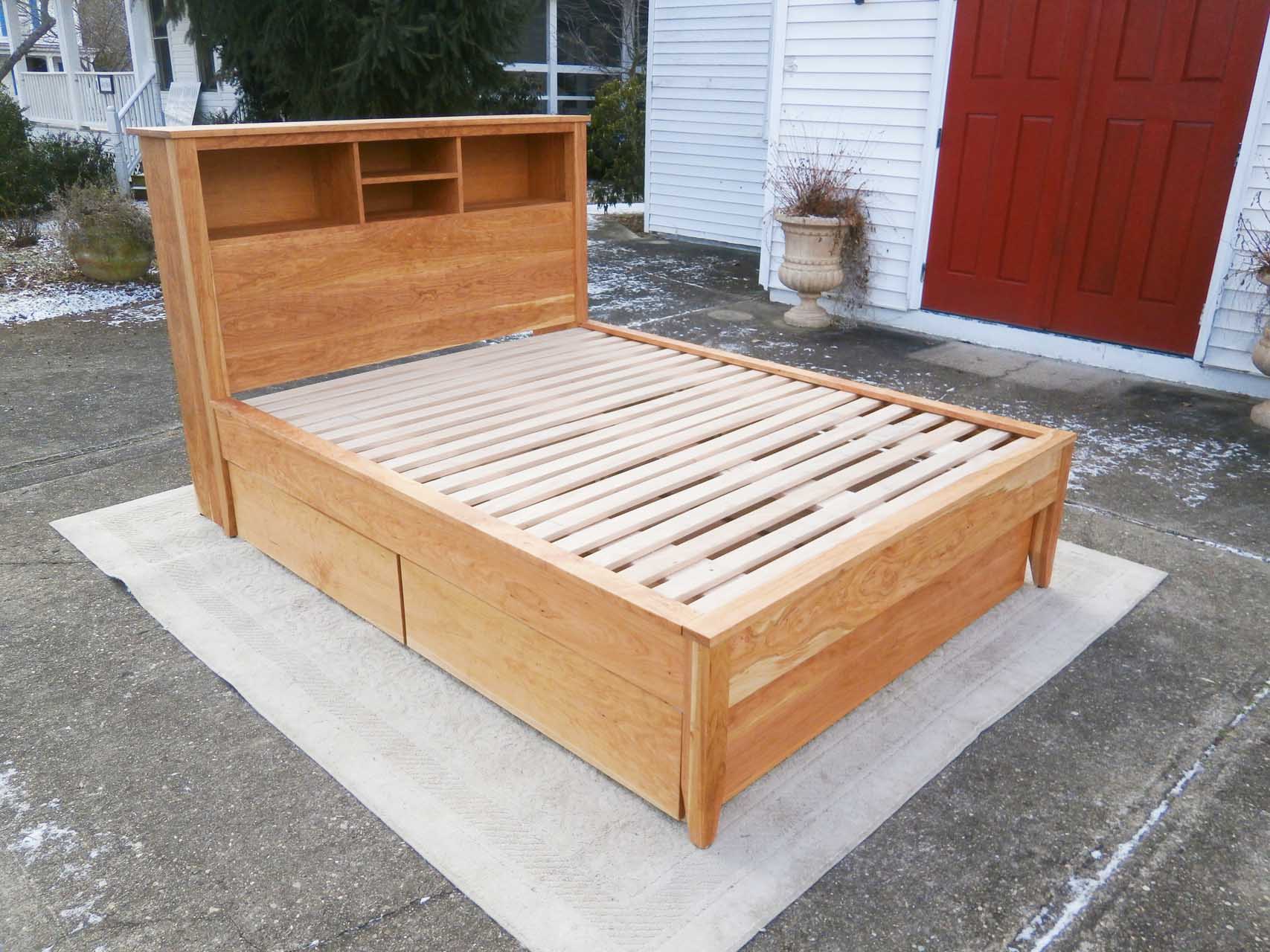 angled view platform bed with bookcase headboard and 4 drawers