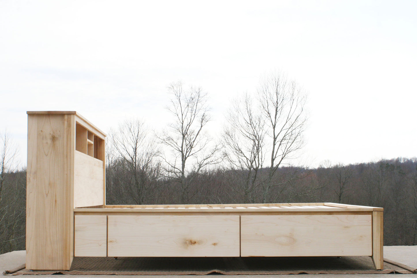 side view Storage bed with bookcase headboard and 4 drawers