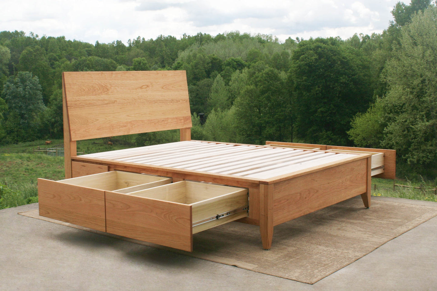 Platform storage bed with headboard angled view with drawers open