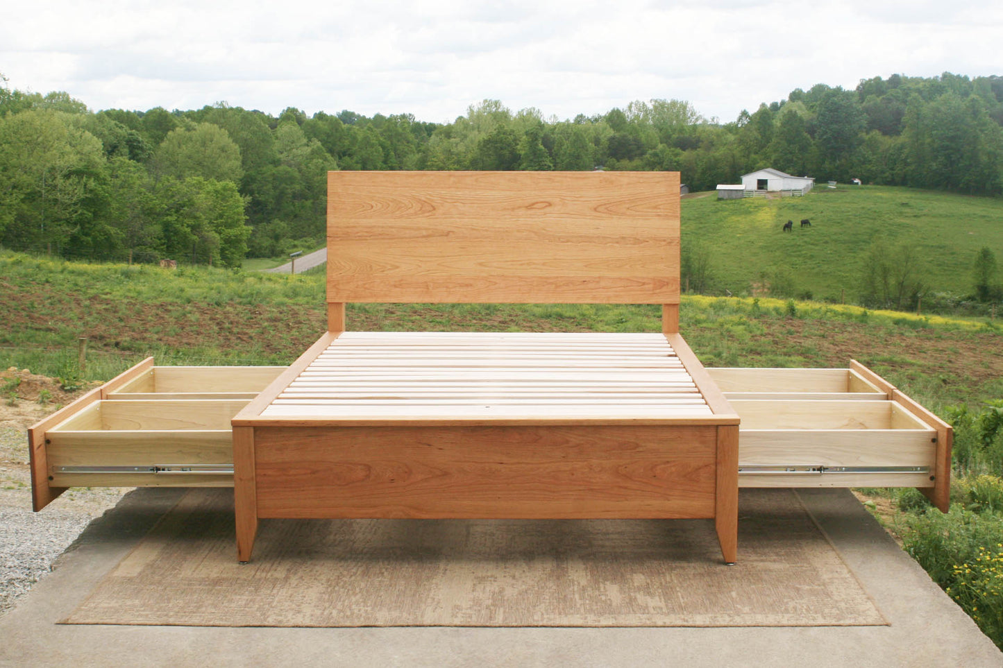 Platform storage bed with headboard front view with drawers open