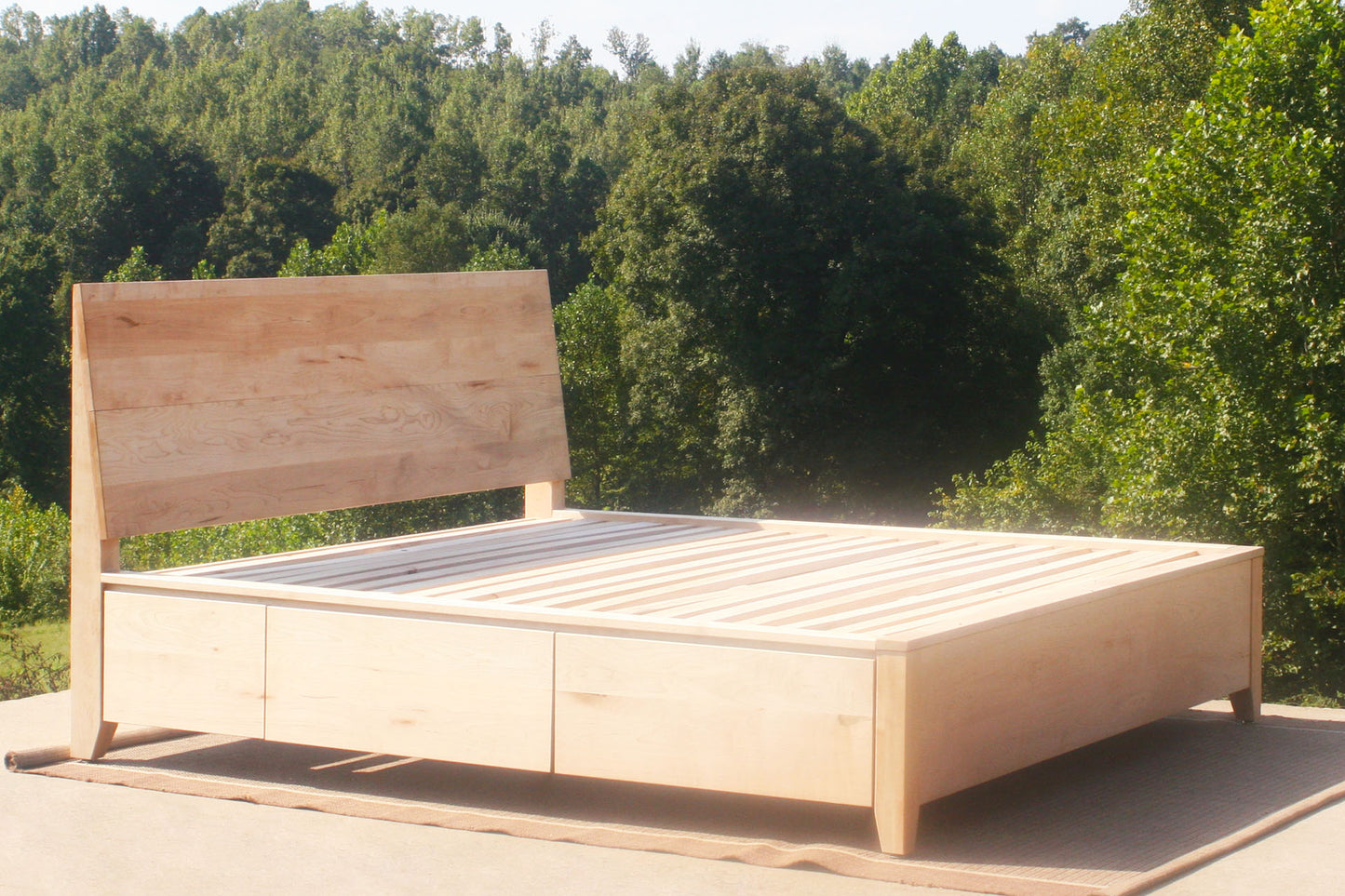 angled view natural Platform storage bed with headboard