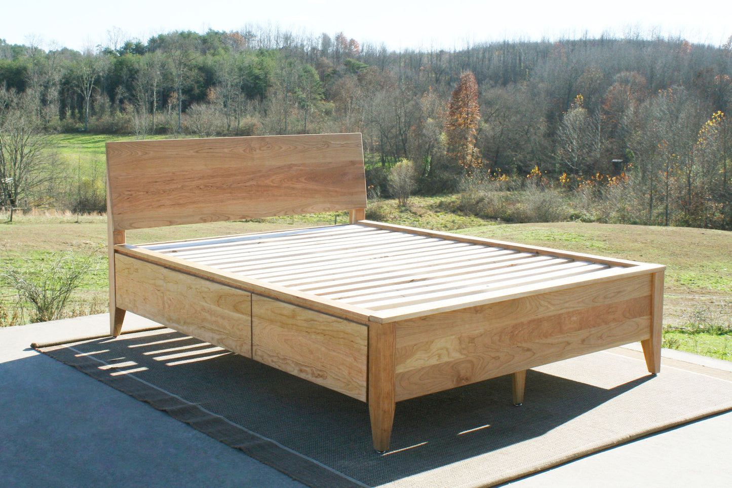 angled view wood Platform storage bed with headboard