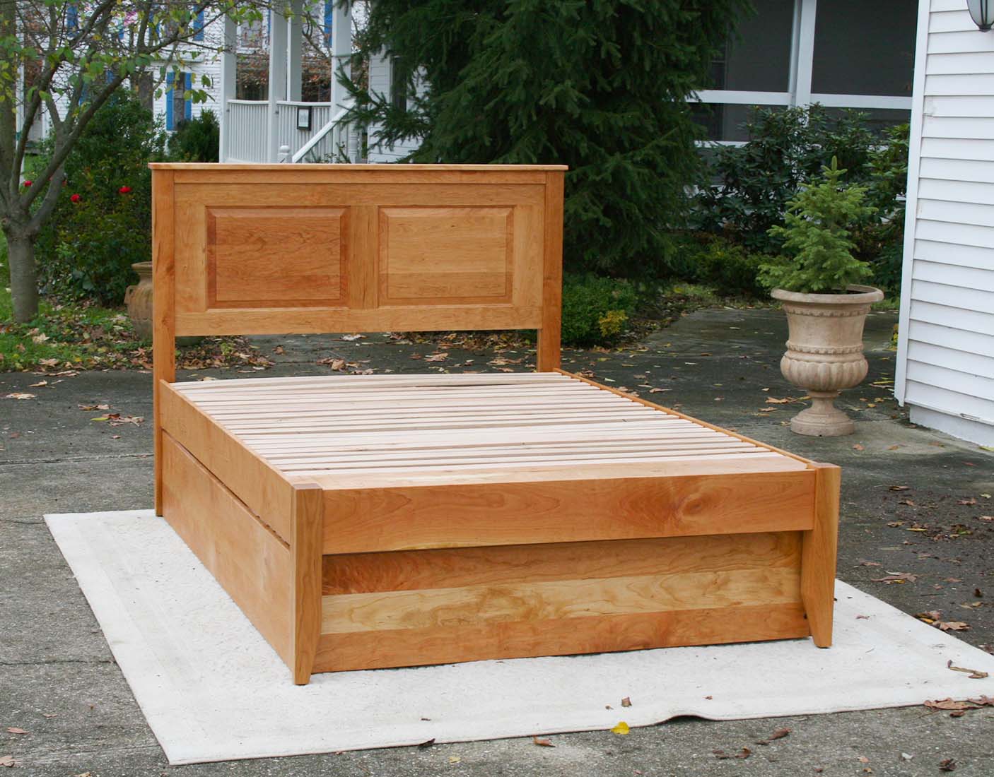 Roll out Trundle Bed with paneled headboard front view