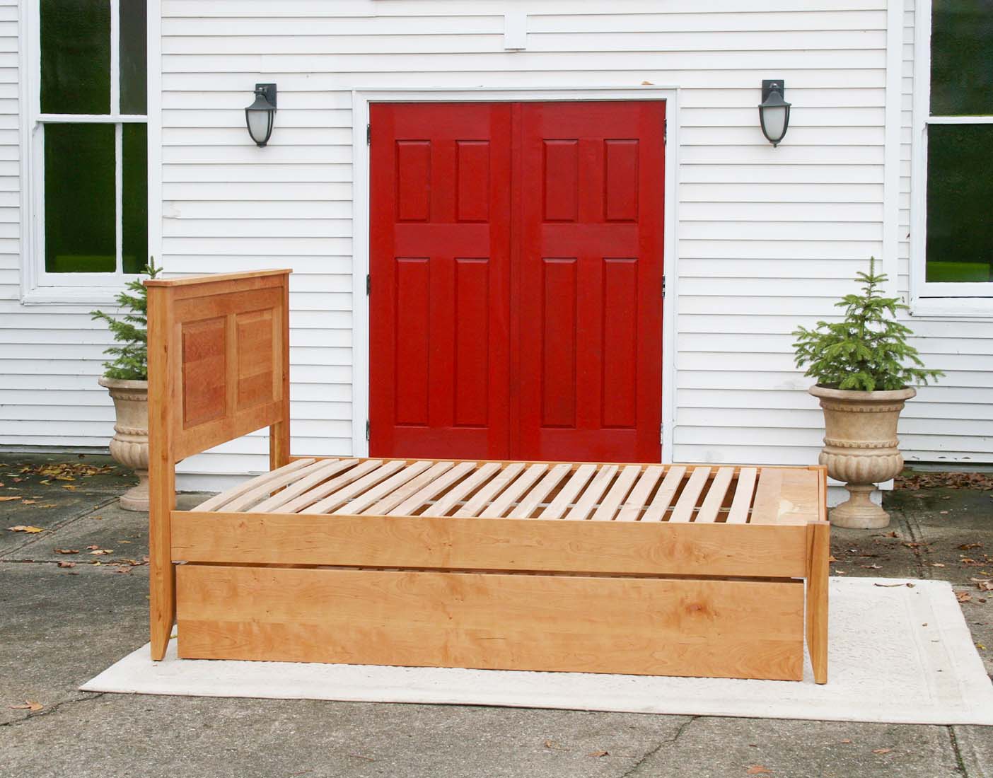 side view natural Roll out Trundle Bed with paneled headboard