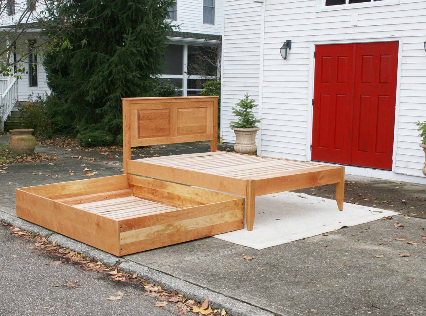 angled view trundle out Roll out Trundle Bed with paneled headboard