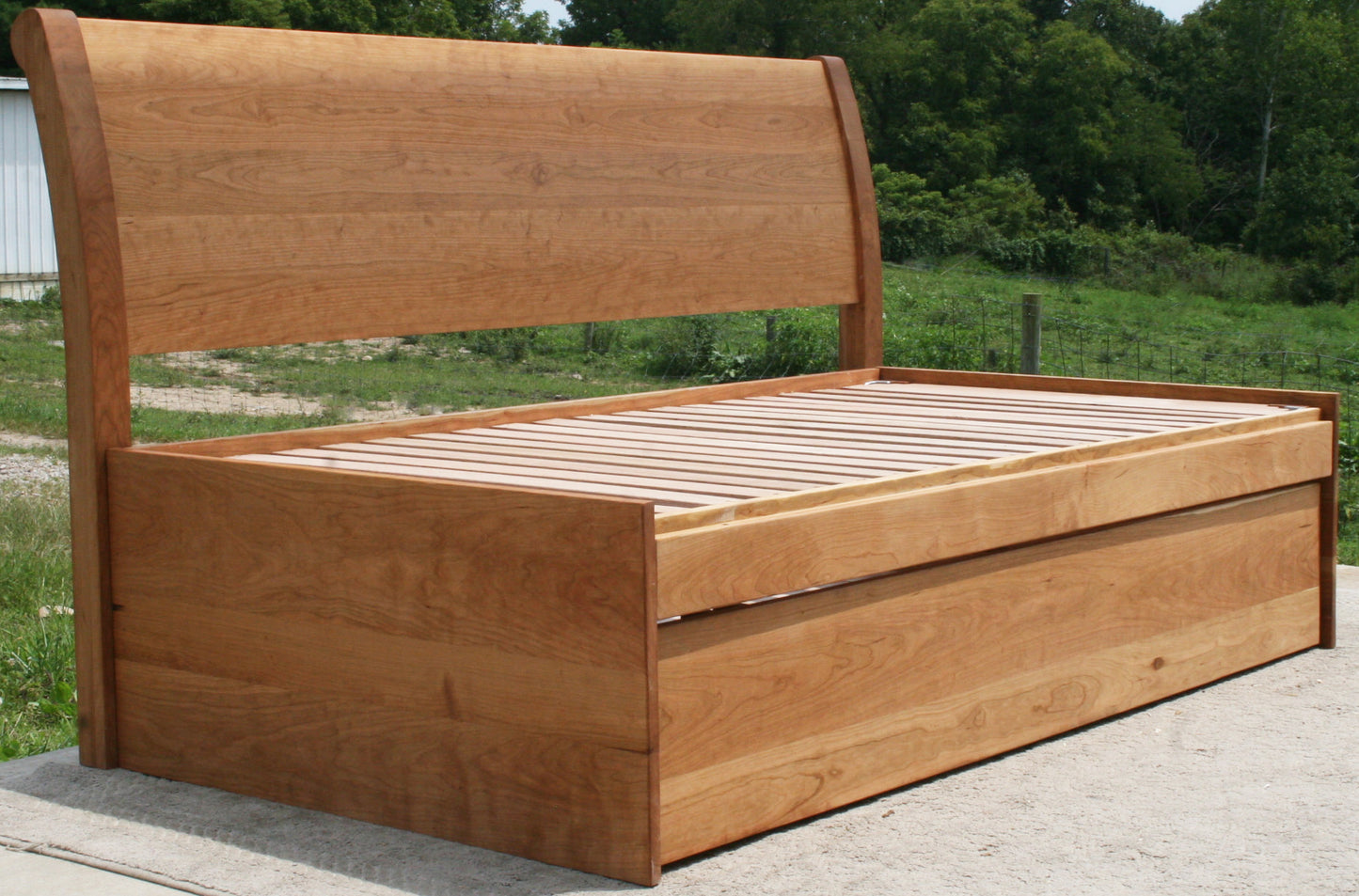 angled view three function pop up trundle bed with sleigh backboard