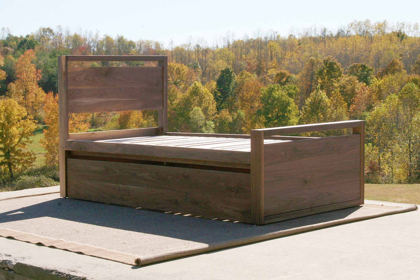 angled view natural Trundle Bed with top rails on headboard and footboard