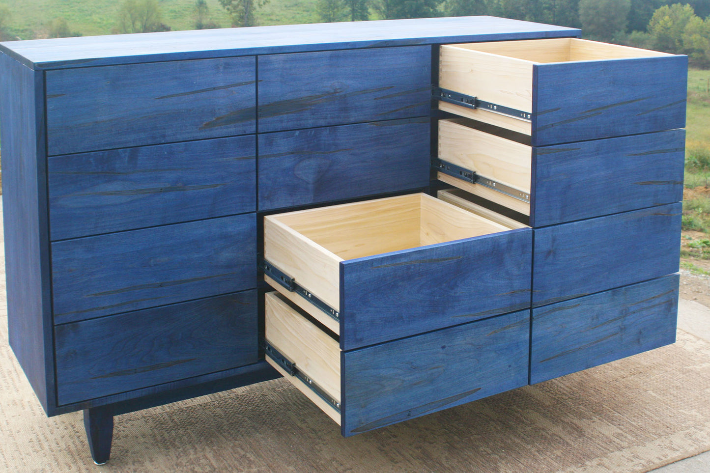 12 Drawer Dresser Chest with Inset opened Drawers and Flat Panels blue stain close up