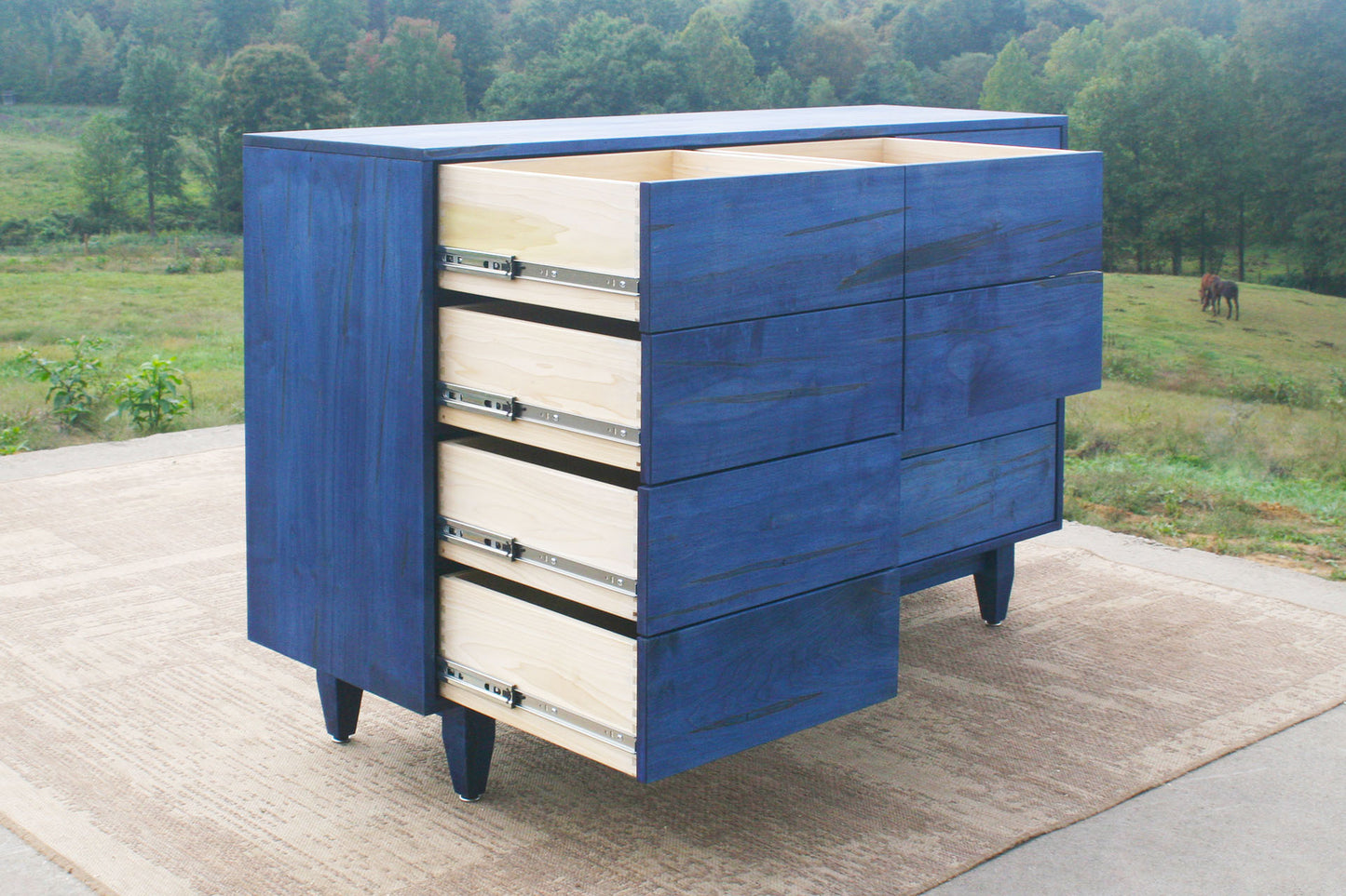 12 Drawer Dresser Chest with opened Inset Drawers and Flat Panels blue stain angled view