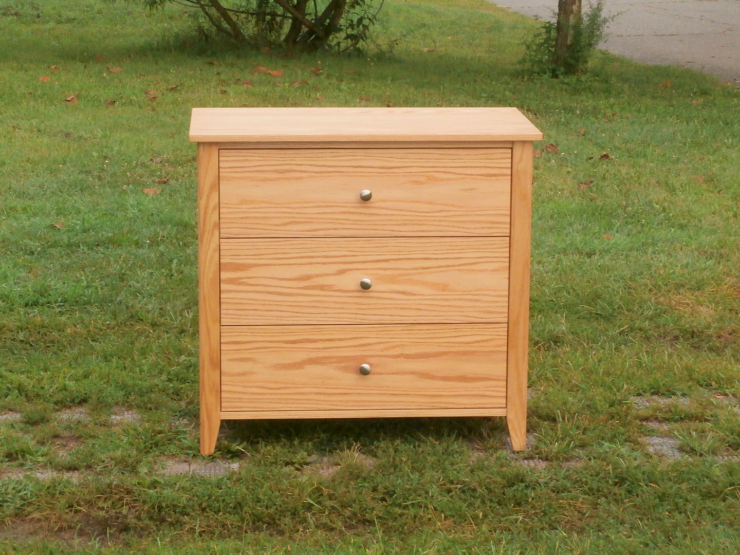 zoomed out front view three drawer dresser hardwood