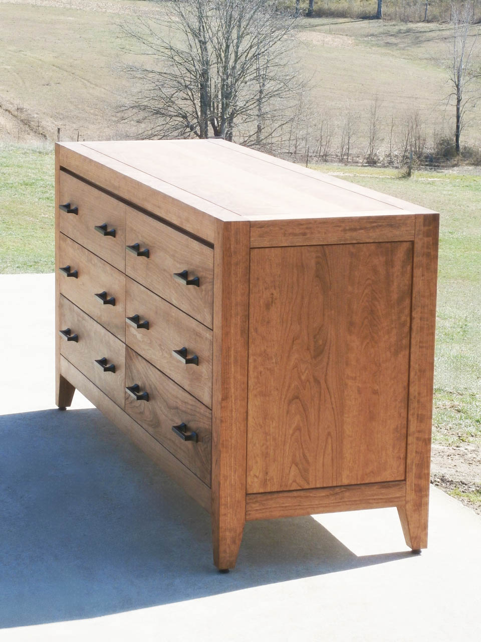 dresser with 6 drawers with long pulls natural hardwood angled view