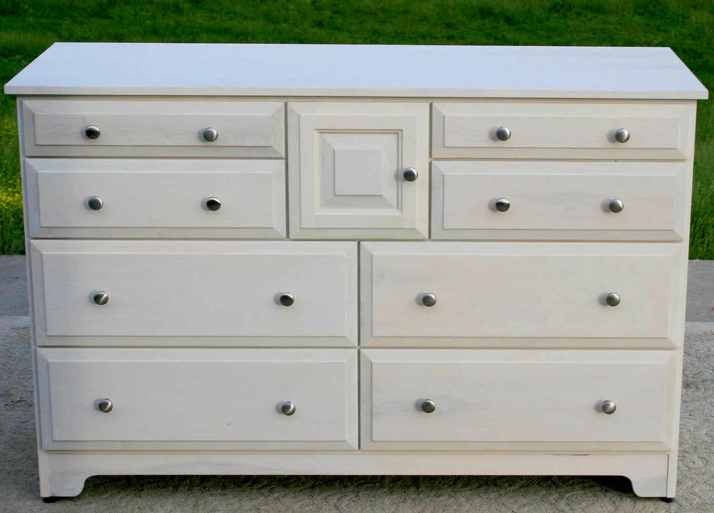 white dresser with 8 drawers and door