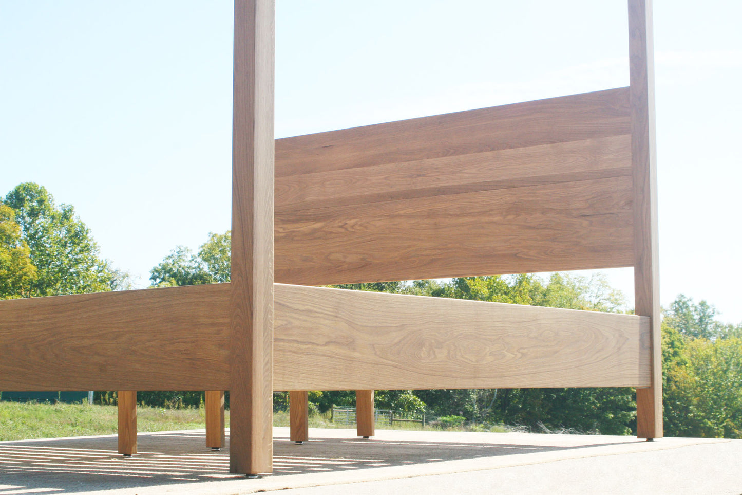 low angled view natural Canopy Bed with a square headboard