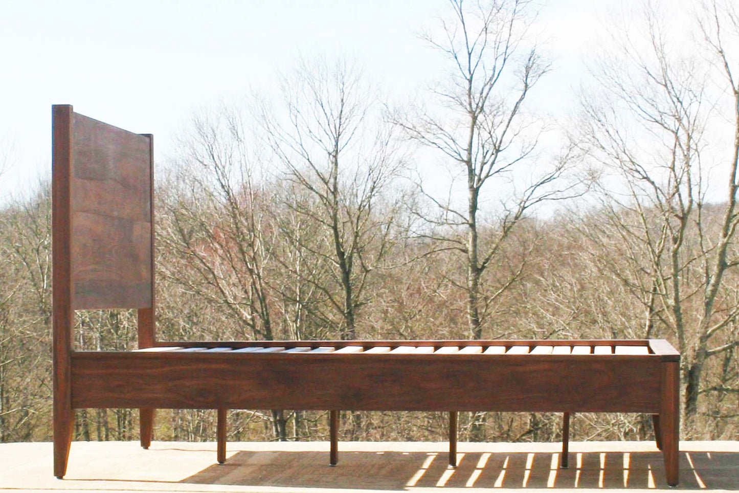 platform bed with curved headboard side view walnut