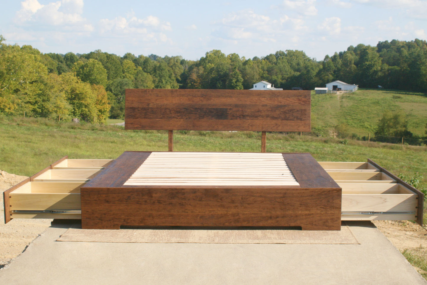 low platform bed with 6 drawers open and angled headboard