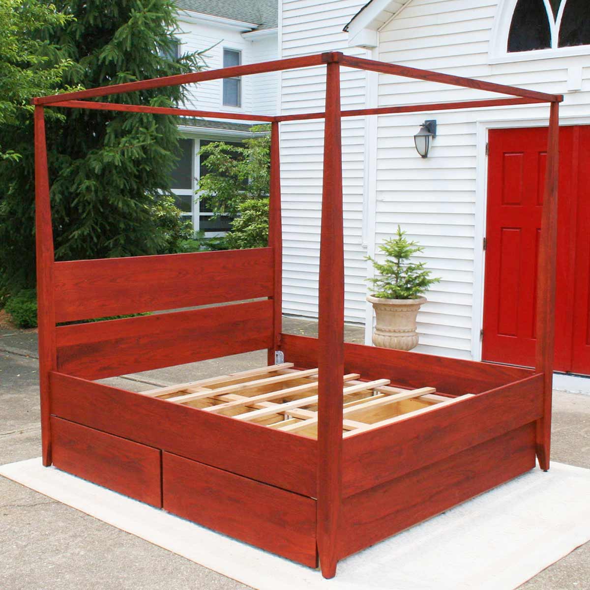 angled view canopy bed with headboard and 4 drawers box spring base