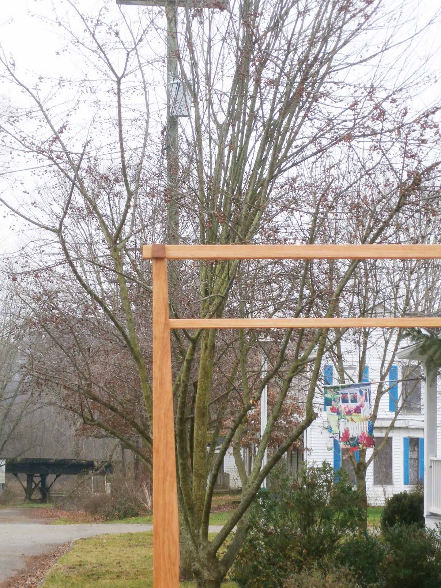 close up of a canopy of a canopy bed with low platform large rail canopy and tapered posts