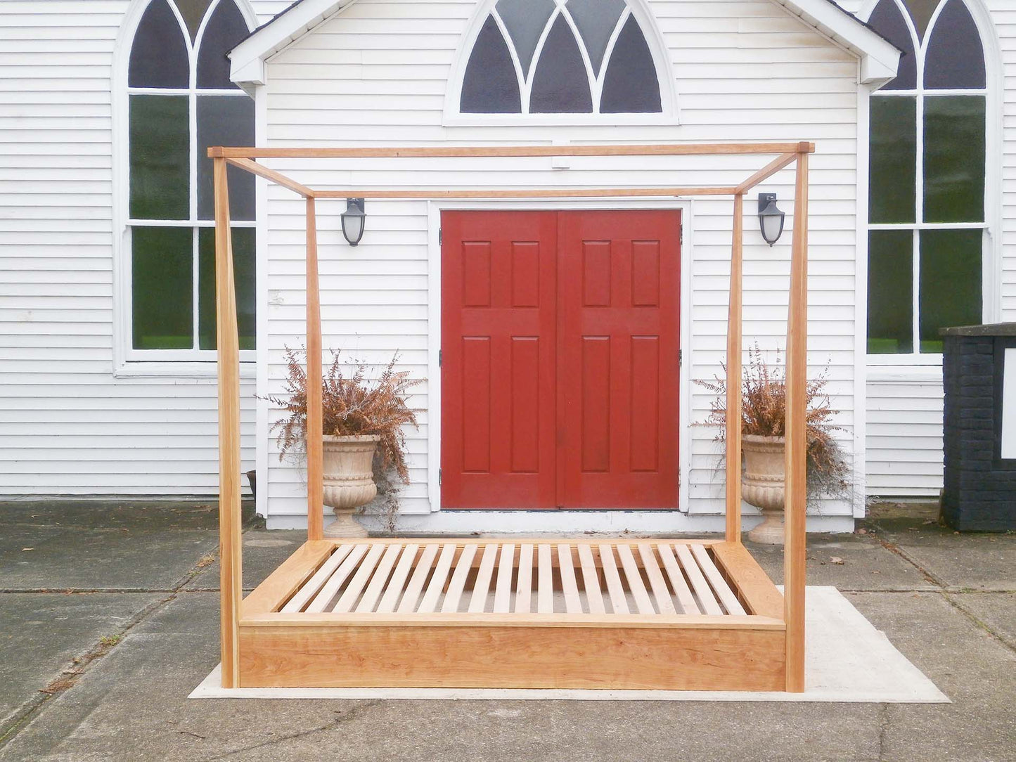side view canopy bed with low platform large rail canopy and tapered posts