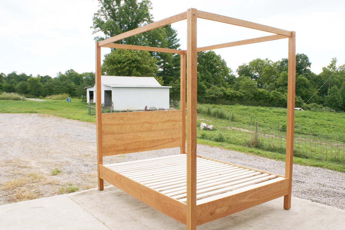 angled view natural canopy bed with straight posts and top rails