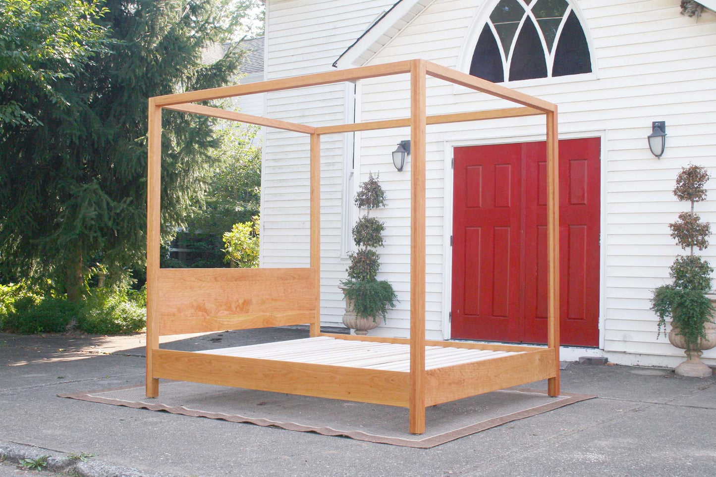 side angled view natural canopy bed with straight posts and top rails
