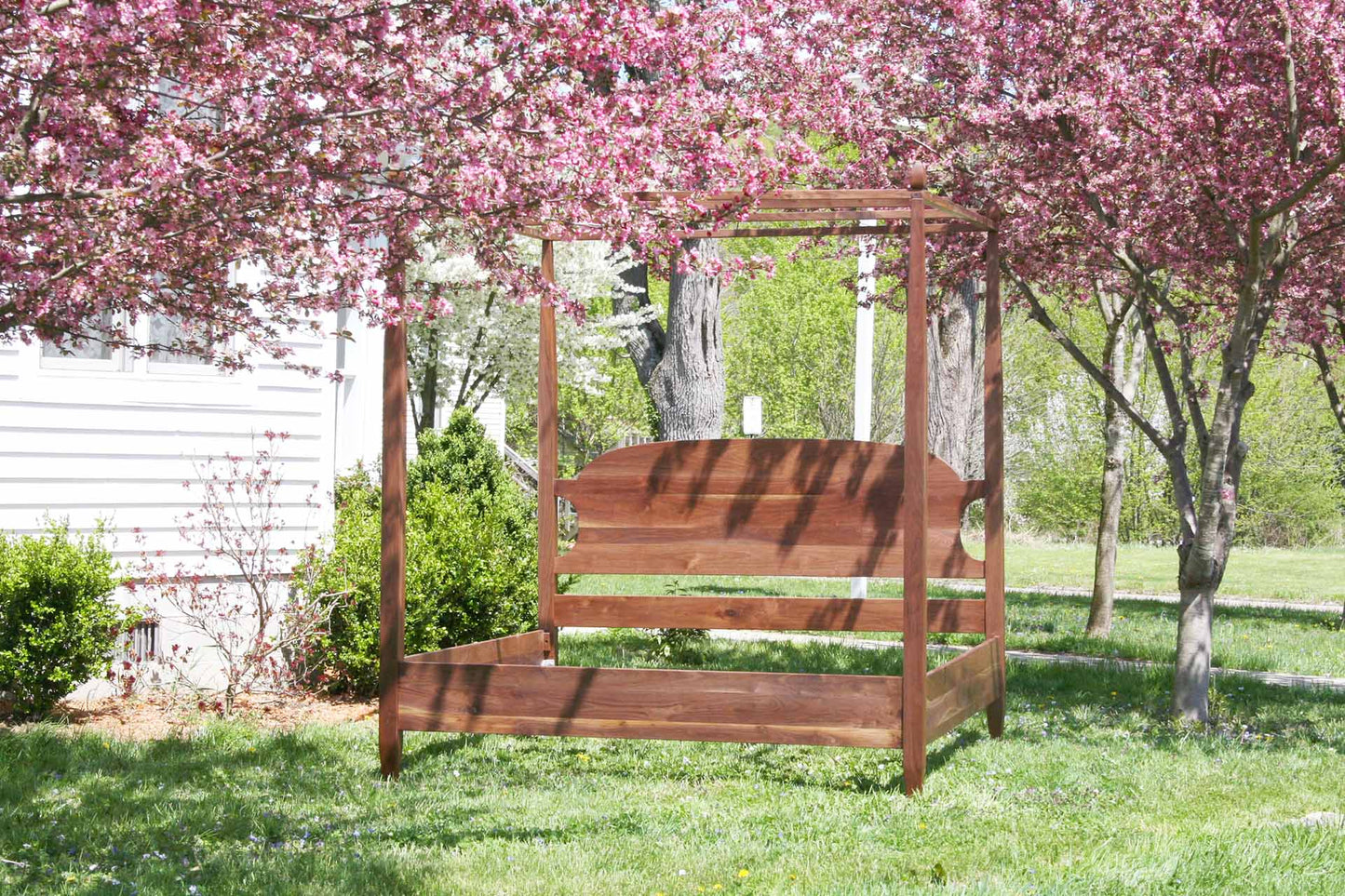 canopy bed with tapered posts and curved headboard front view