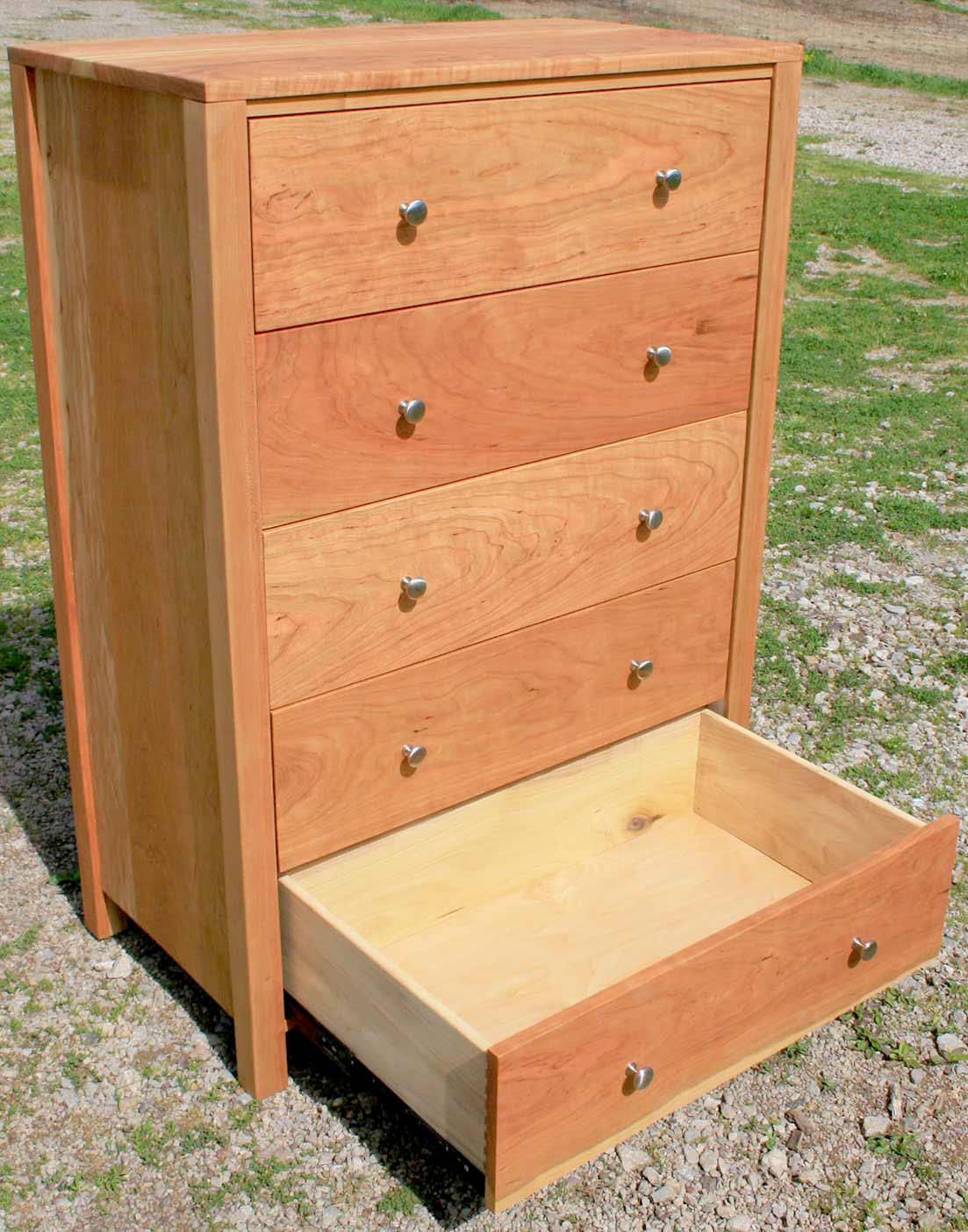 walnut dresser with nickel pulls angled view with bottom drawer open