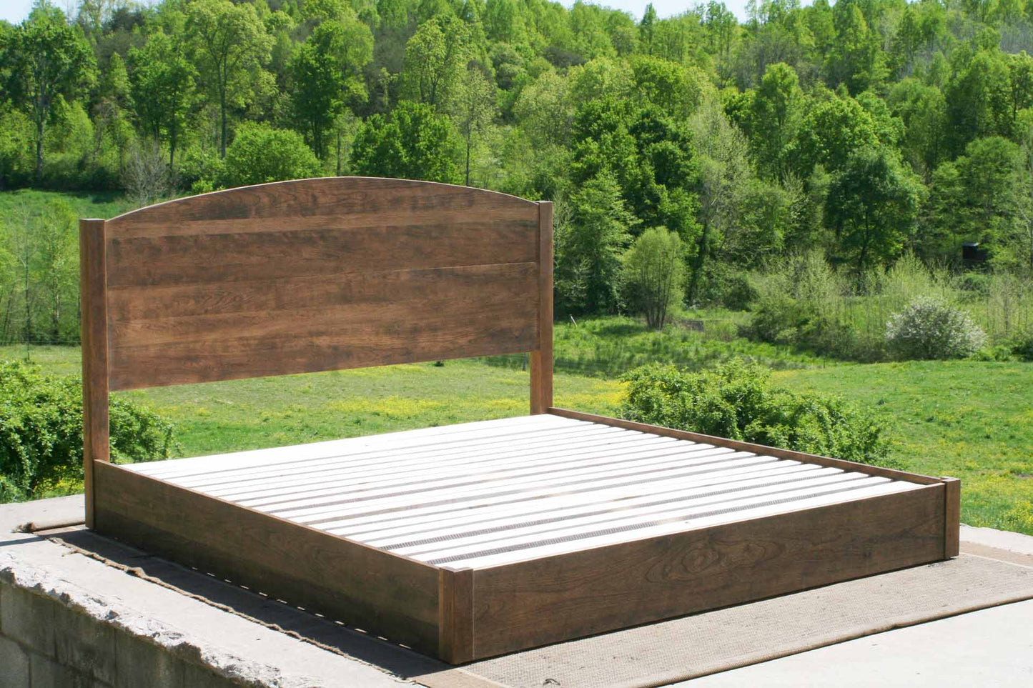 low platform bed with arched headboard side view