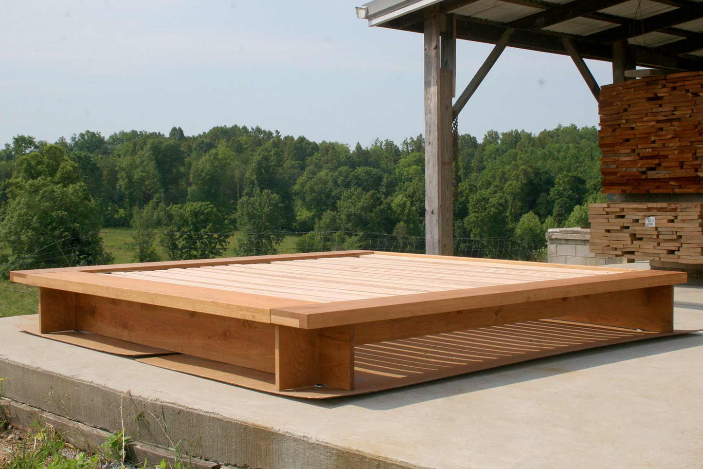 angled view hardwood low platform bed with wide platform and optional side tables