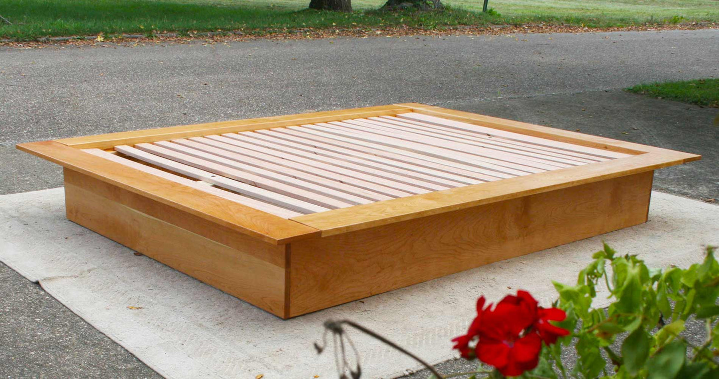 angled view natural Low Platform Bed with no headboard and wide platform extensions