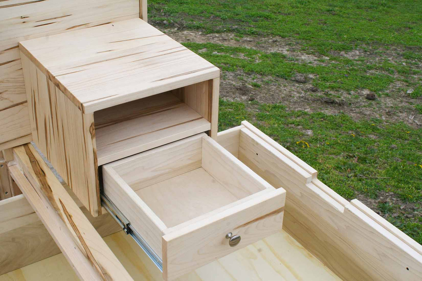 drawer open of Platform Bed with 4 drawers, wide headboard and built-in side tables angled view