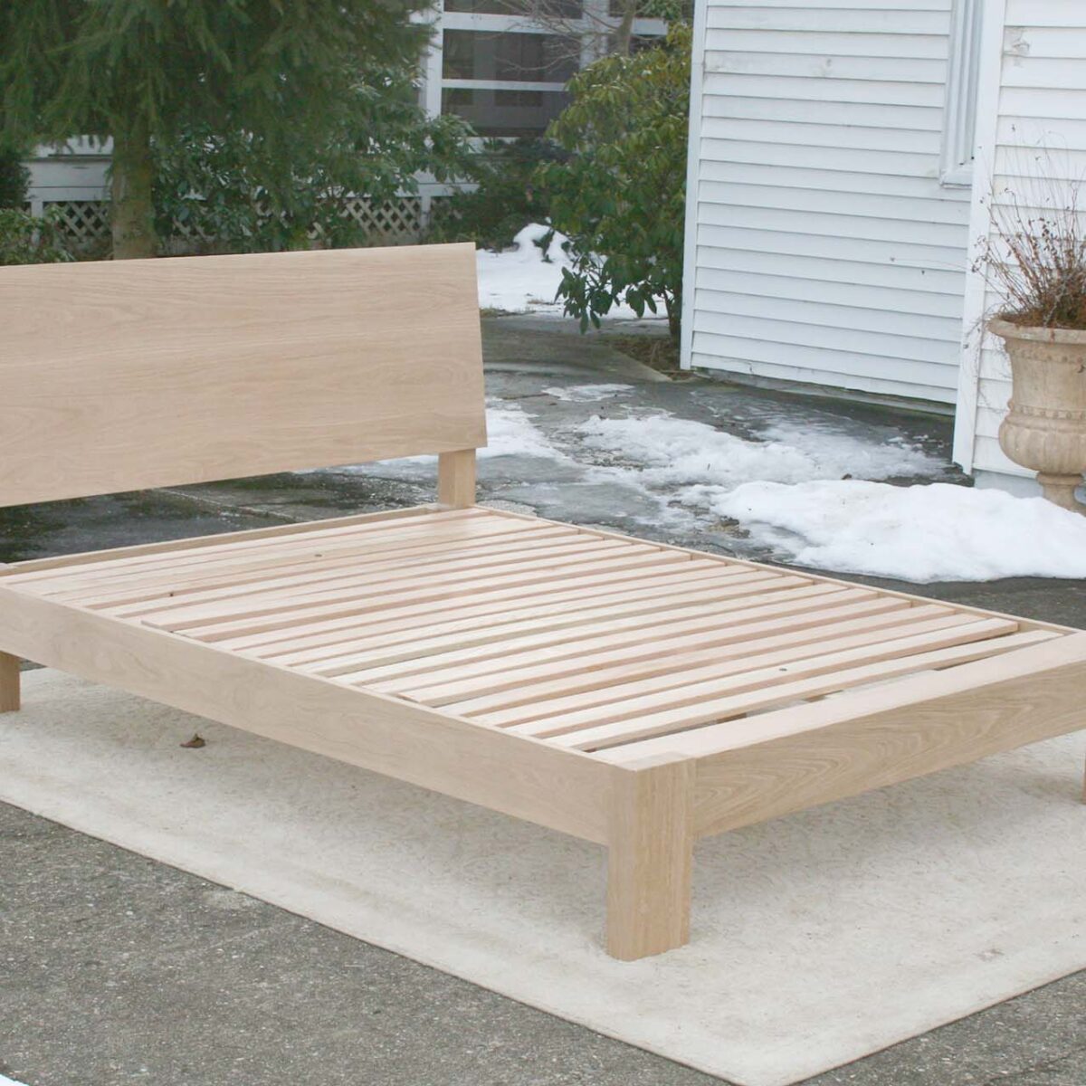 sturdy platform bed with angled headboard and wide thick posts top natural angled view