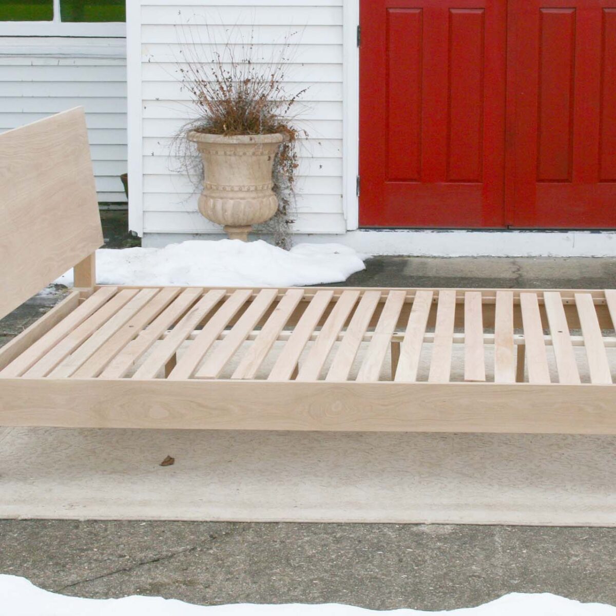 sturdy platform bed with angled headboard and wide thick posts top side view