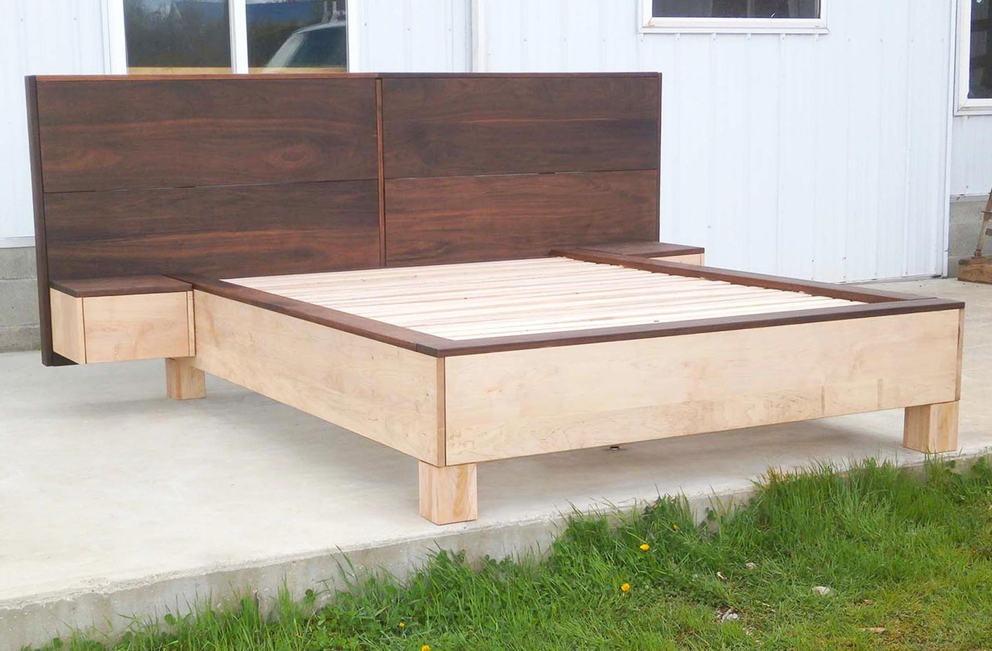 front view platform bed with large headboard and attached side tables