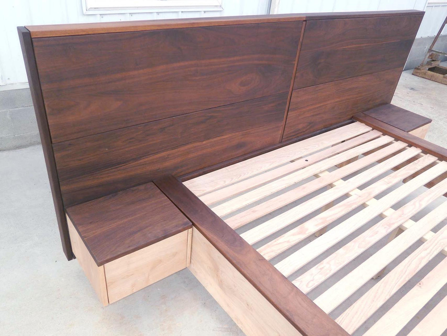 headboard of platform bed with large headboard and attached side tables