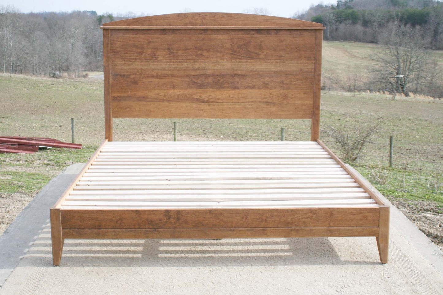 front view platform bed with tall arched headboard