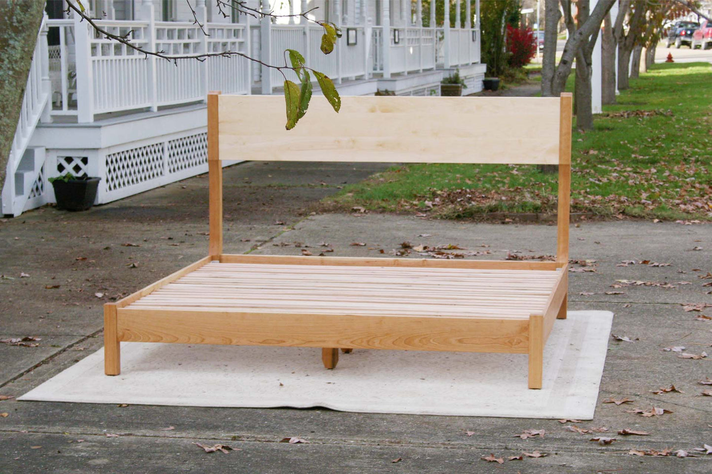front view platform bed with tall headboard and curved posts