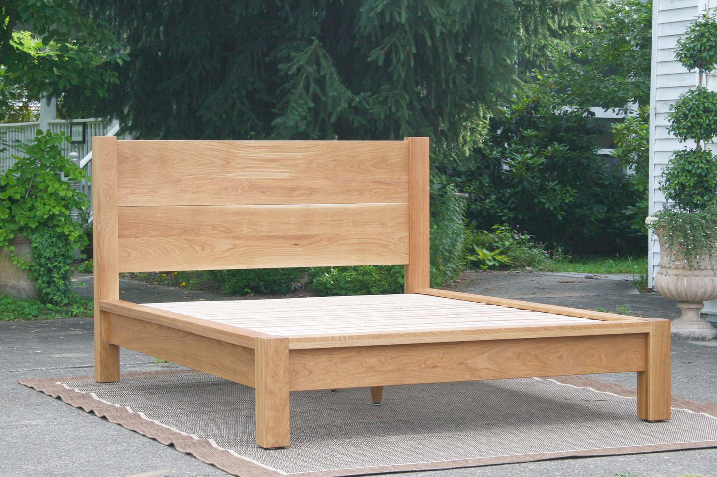 front view natural platform bed with thick posts and vertical headboard