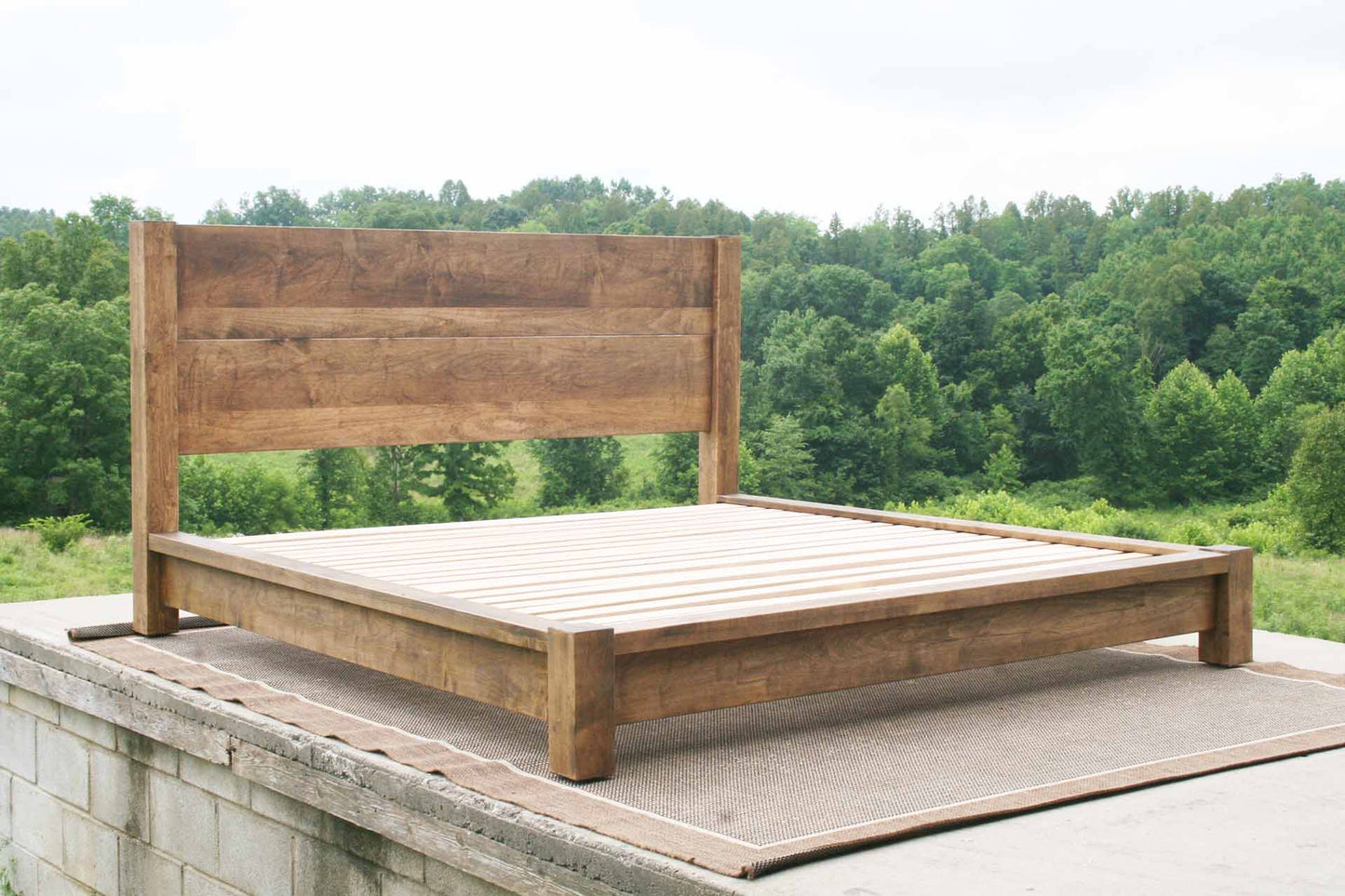 front angled view platform bed with thick posts and vertical headboard