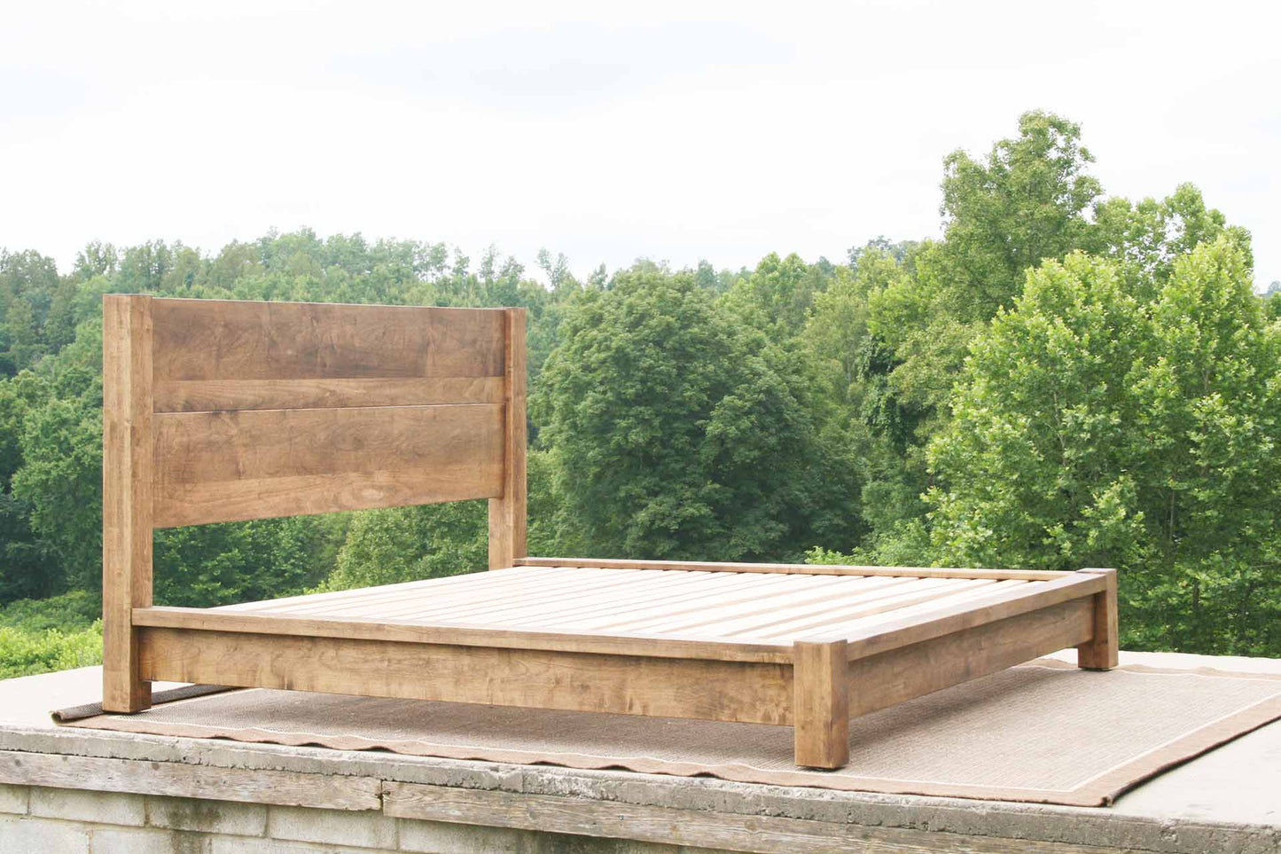 platform bed with thick posts and vertical headboard angled view