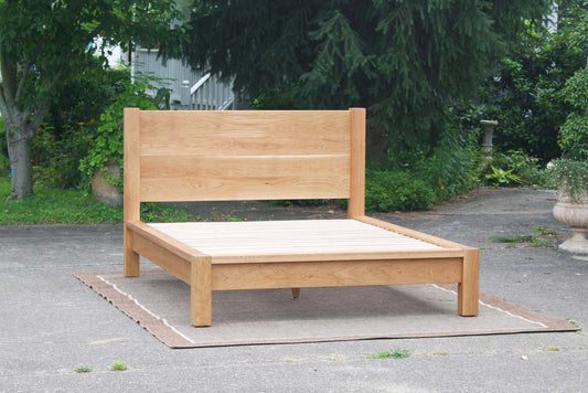 platform bed with thick posts and vertical headboard